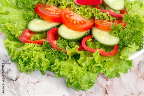 Tasty fresh salad with vegetables on the desk
