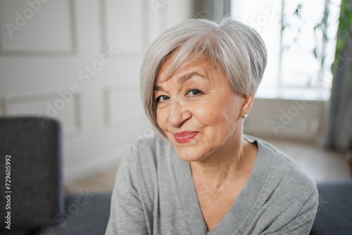 Portrait of confident stylish european middle aged senior woman. Older mature 60s lady smiling at home. Happy attractive senior female looking camera close up face headshot portrait. Happy people