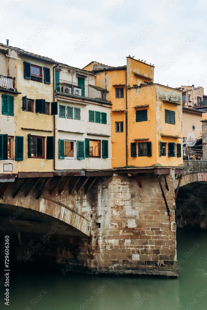 The Ponte Vecchio, a medieval stone closed-spandrel segmental arch bridge over the Arno, in Florence, Italy