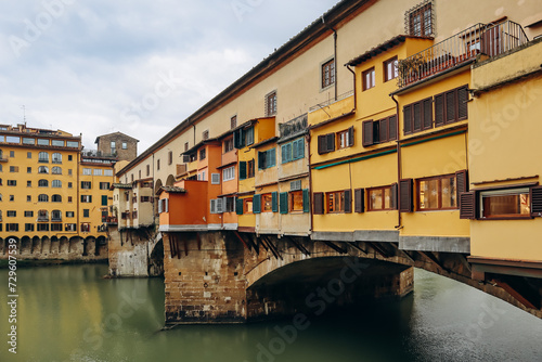 The Ponte Vecchio, a medieval stone closed-spandrel segmental arch bridge over the Arno, in Florence, Italy