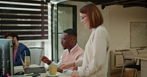 Colleagues from diverse backgrounds come together for a coffee break in a modern office, fostering camaraderie and relaxation in the dynamic workplace.