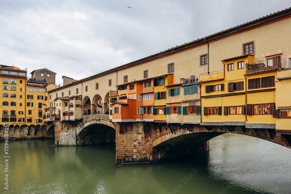 The Ponte Vecchio, a medieval stone closed-spandrel segmental arch bridge over the Arno, in Florence, Italy