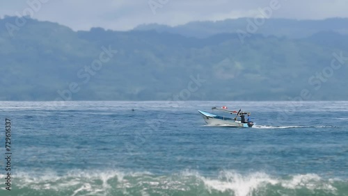 Fishing Boat with Two Fishermen Sailing the Sea