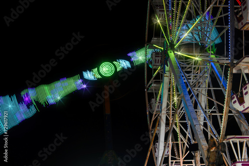 Mexican fair with rides and lights at night, with space for text