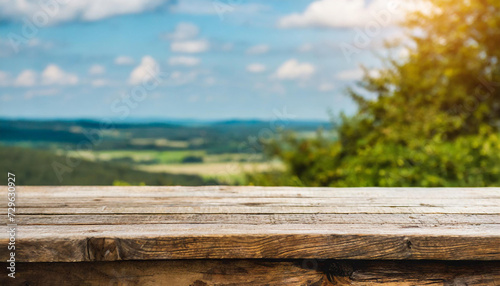 Empty rustic table in front of countryside background. product display and picnic concept