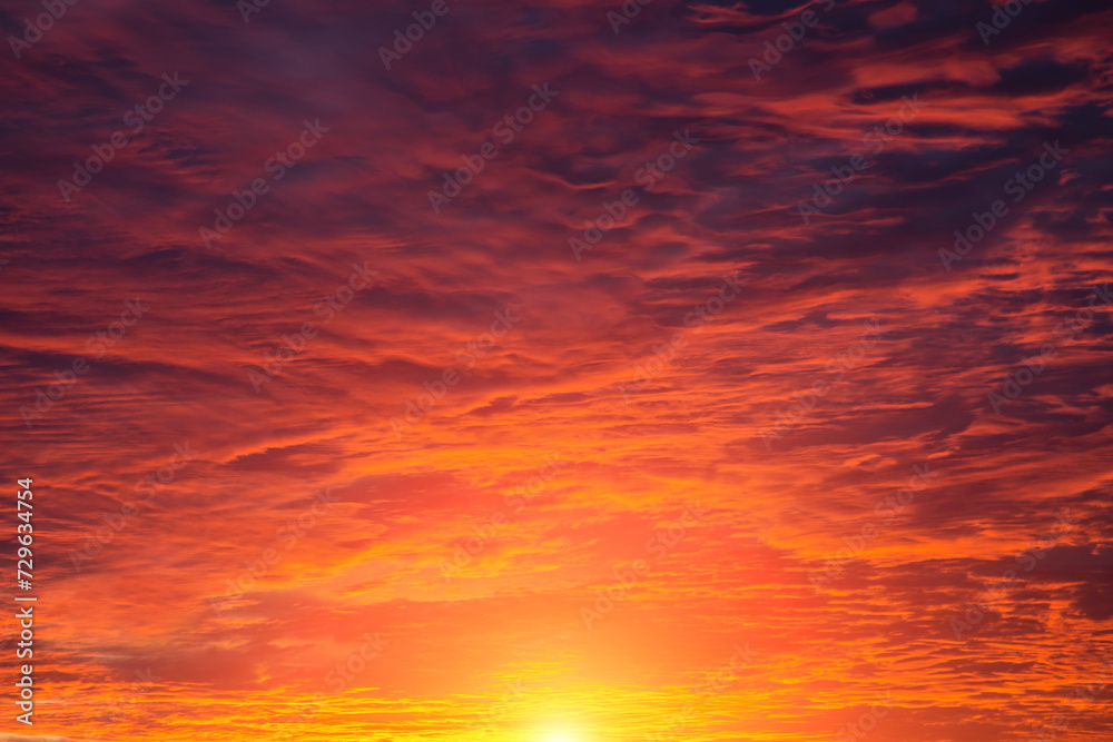 Epic Dramatic soft sunrise, sunset red orange sky with clouds and yellow sun and sunlight abstract background texture Epic Dramatic soft sunrise, sunset red orange sky with clouds and yellow sun and sunlight abstract background texture