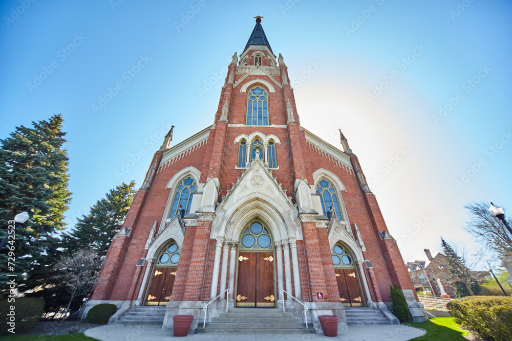 Gothic Revival Church with Central Spire and Stained Glass, Sunlit Halo Effect