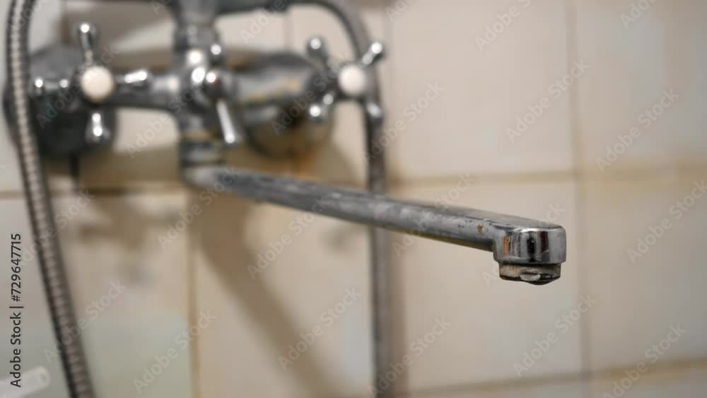 Old leaky faucet. Dripping faucet. Water dripping from the faucet. Plumbing covered with limescale. Plumbing in need of repair. Save water. Leaking Water tap. Household equipment service. Wasted water Old leaky faucet. Dripping faucet. Water dripping from the faucet. Plumbing covered with limescale. Plumbing in need of repair. Save water. Leaking Water tap. Household equipment service. Wasted water