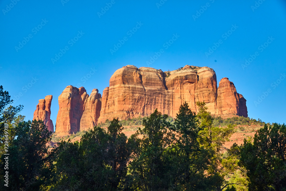 Majestic Red Sandstone Cliffs and Evergreens in Sedona