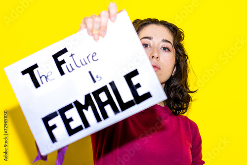 Woman Presenting "The Future Is Female" Slogan Sign