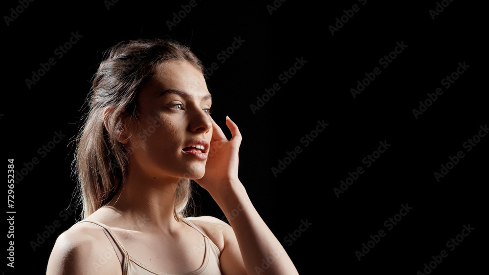 Young confident model using face cream in beauty ad, applying professional serum on luminous bare skin. Flawless natural girl using moisturizer or sunscreen on face, body campaign. Young confident model using face cream in beauty ad, applying professional serum on luminous bare skin. Flawless natural girl using moisturizer or sunscreen on face, body campaign.