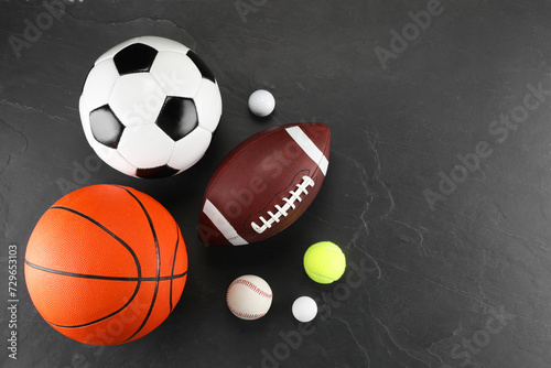 Many different sports balls on dark gray background  flat lay. Space for text