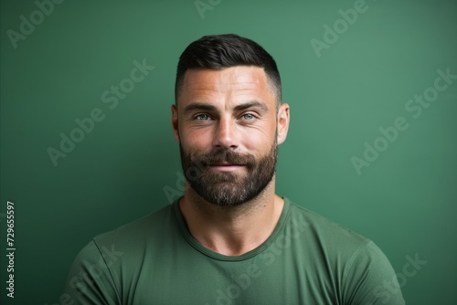 Portrait of a handsome bearded man in a green t-shirt