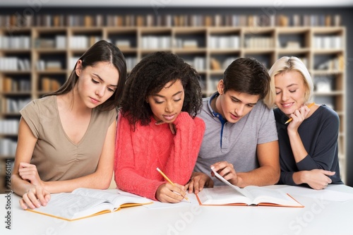 Happy students study together during class.