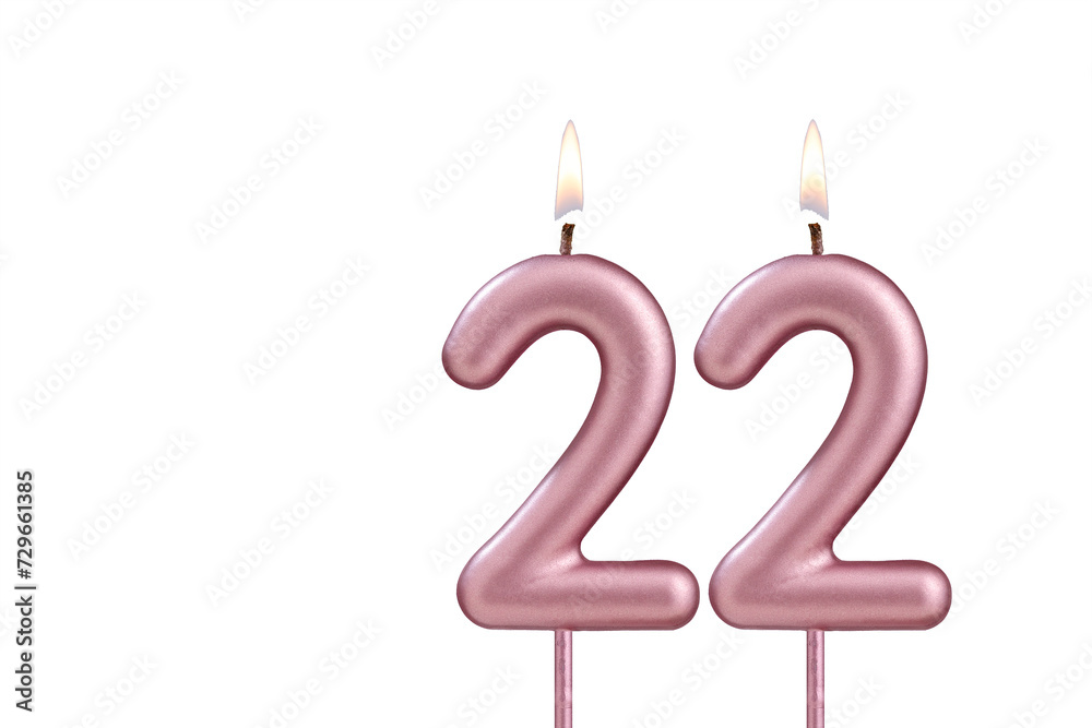 Candle number 22 - Lit birthday candle on white background Candle number 22 - Lit birthday candle on white background