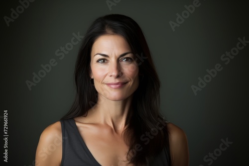 Portrait of a beautiful woman with long black hair on a dark background