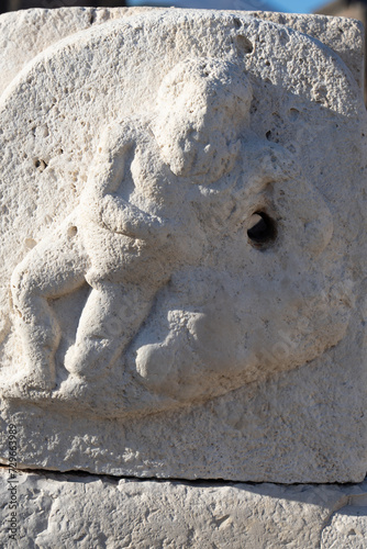 Human figure carved in water fountain stone in Pompeii Archaeological Park