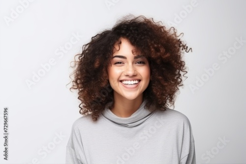Portrait of a happy young african american woman with curly hair © Asier