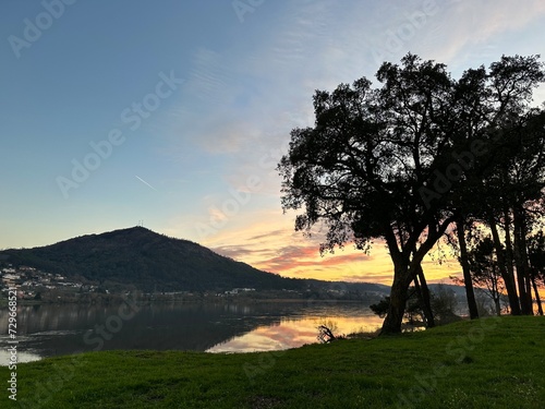 Sunset over the river Minho, mountain and the trees near Eiras, O Rosal, Galicia, Spain, January 2023 photo
