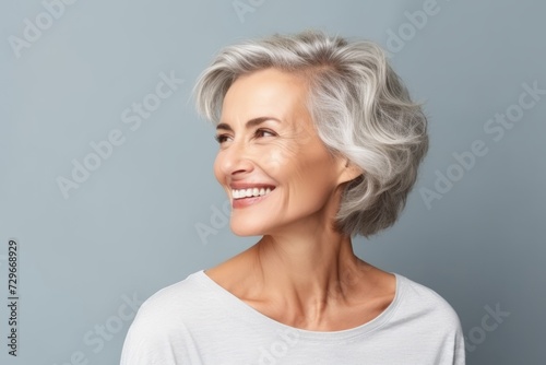 beauty, people and health concept - smiling senior woman over grey background