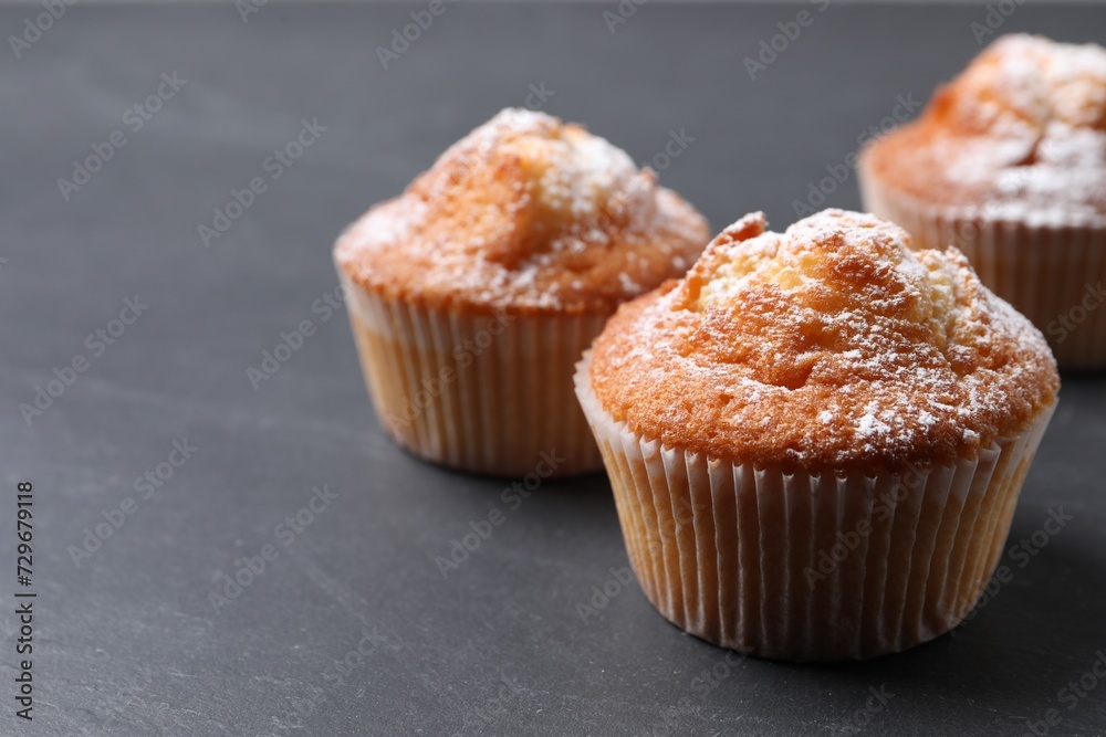 Delicious sweet muffins on black table, closeup. Space for text Delicious sweet muffins on black table, closeup. Space for text