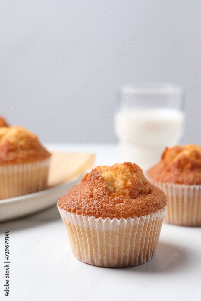 Delicious sweet muffins on white table, closeup. Space for text Delicious sweet muffins on white table, closeup. Space for text