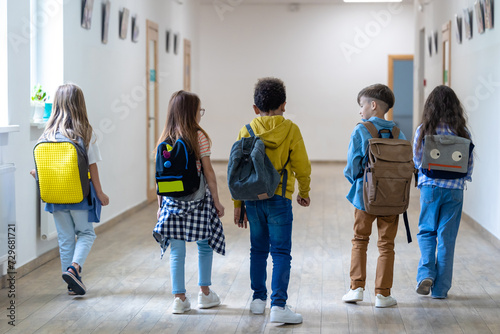 Wallpaper Mural Back view of group of elementary school kids standing in school corridor. Torontodigital.ca