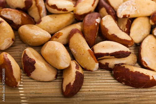 Brazil nuts on wooden surface, closeup