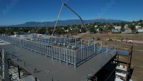 Aerial view of a concrete pour on a commercial building with mountains