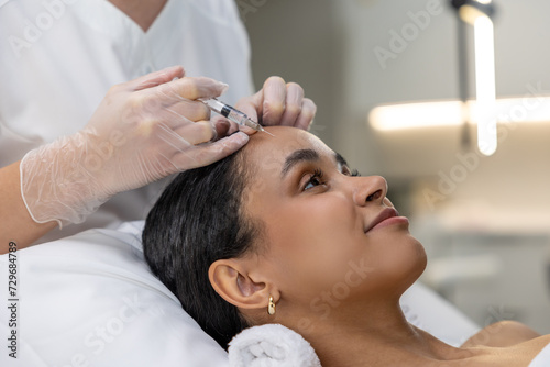 Young woman having a session of hair plasmotherapy