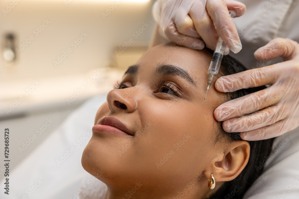 Smiling woman on a mesotherapy treatment session Smiling woman on a mesotherapy treatment session