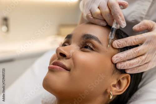 Smiling woman on a mesotherapy treatment session