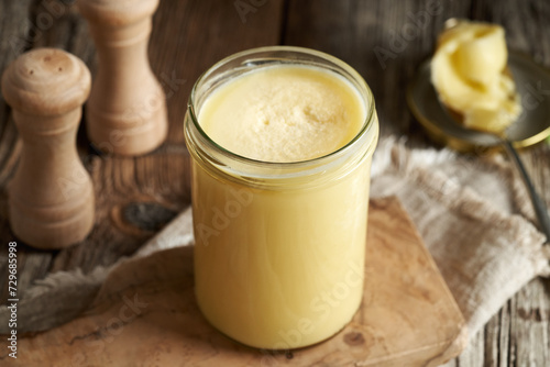 Ghee or clarified butter in a glass jar on a table