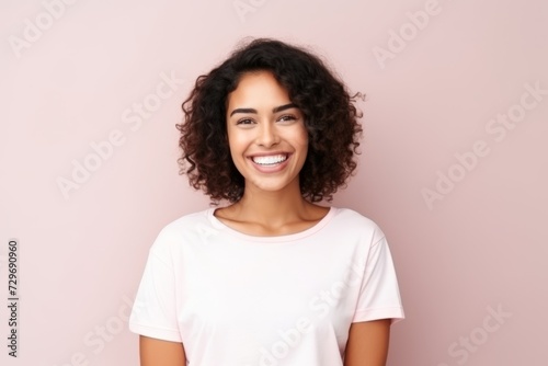 Portrait of a happy young african american woman smiling over pink background