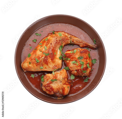 Tasty cooked rabbit meat with sauce and parsley isolated on white, top view