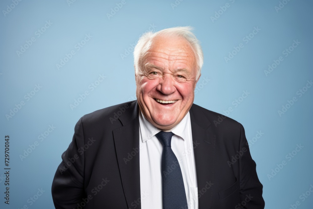 Portrait of a senior business man laughing on blue background with copy space Portrait of a senior business man laughing on blue background with copy space