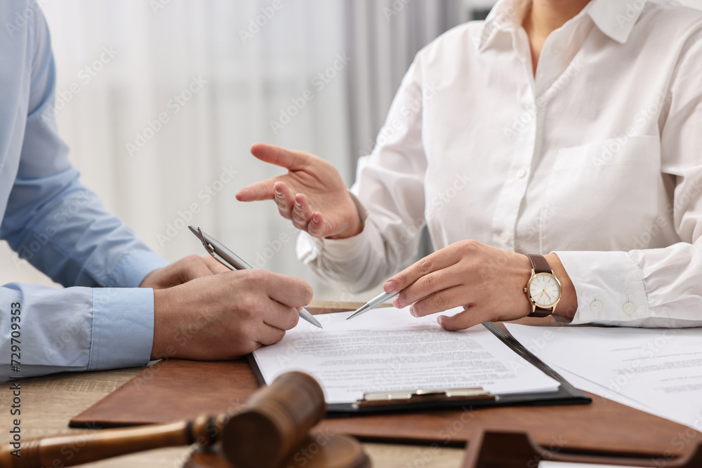 Lawyers working with documents at table in office, closeup Lawyers working with documents at table in office, closeup