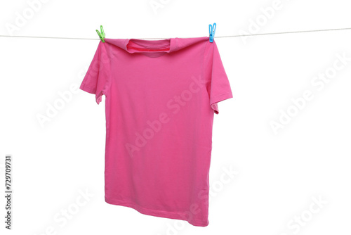 Pink t-shirt drying on washing line against white background