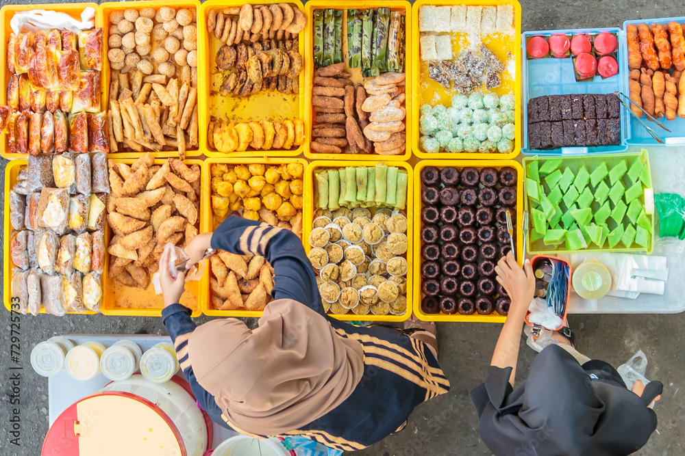 Variety of delicious and colorful Malaysian home cooked local cakes sold at street market stall in Kota Kinabalu Sabah from top angle view.