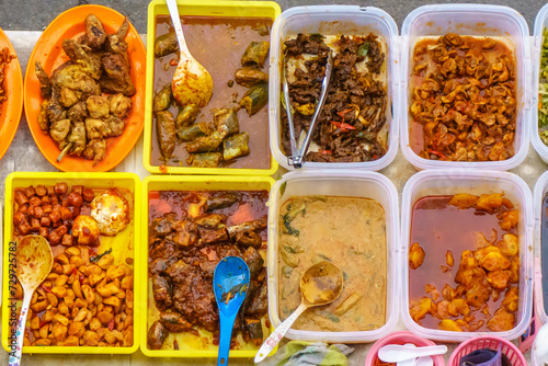 Variety of delicious Malaysian home cooked dishes sold at street market stall in Kota Kinabalu Sabah photo