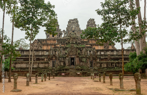 Stone beautiful a temple ruin building architecture in lush green forest in Phnom Bakheng complex Angkor Wat in Seim Reap Cambodia on a cloudy overcast day