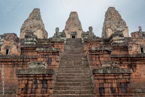 Red brick and stone temple ruin building pagoda structures complex Pre Rup Angkor Wat historical site park in the forest of Siem Reap Cambodia
