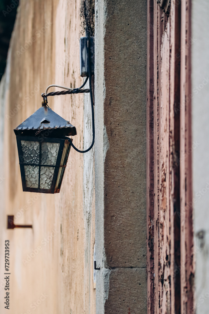 Beautiful old lantern on an ocher wall in the center of Florence