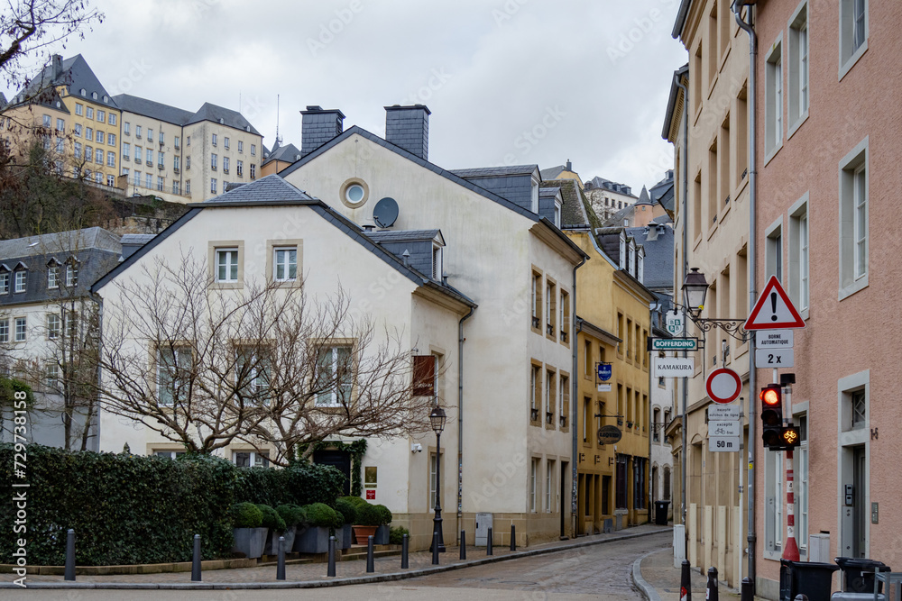 Colorful pink, yellow, and grey buildings in the old town village along a walled cliff of Luxembourg City Europe
