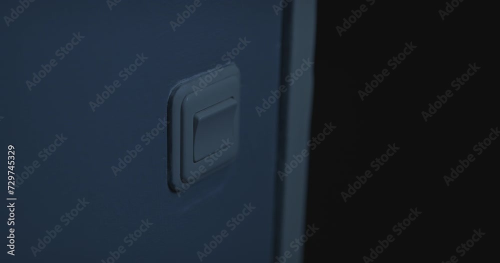 Horror scene - Hand flipping light switch. A lamp in another dark room quickly turns on and off indicating the bulb popped Horror scene - Hand flipping light switch. A lamp in another dark room quickly turns on and off indicating the bulb popped
