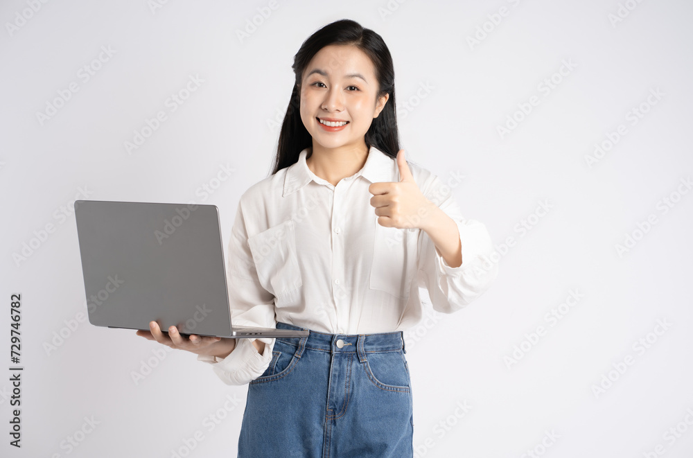 Portrait of young Asian businesswoman using laptop on white background Portrait of young Asian businesswoman using laptop on white background