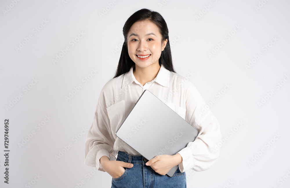 Portrait of young Asian businesswoman using laptop on white background Portrait of young Asian businesswoman using laptop on white background