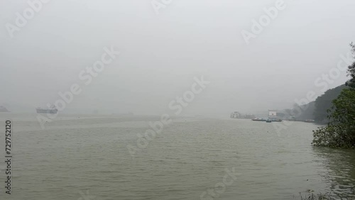 Bare view of Merchant ships and boats stationed at Babughat in a winter foggy morning in Kolkata, India. photo