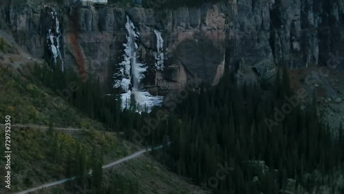 Telluride Colorado aerial drone  Bridal Veil Falls frozen ice waterfall autumn sunset cool shaded Rocky Mountains Silverton Ouray Millon Dollar Highway historic town scenic landscape slow pan up photo