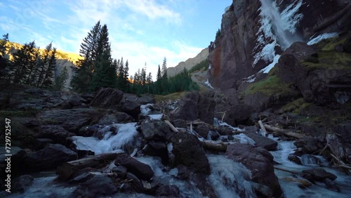 Telluride Colorado sunset stream Bridal Veil Falls frozen ice Waterfall fall autumn sunset cool shaded Rocky Mountains Silverton Ouray Millon Dollar Highway historic town scenic landscape slow pan up photo